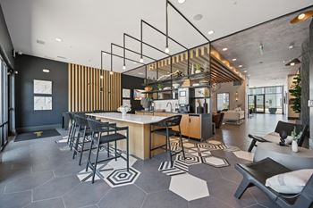 Community clubhouse with kitchen island and lounge seating
